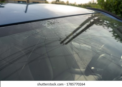 Broken Windshield With A Lot Of Cracks And Small Glass Pieces, Damaged Car