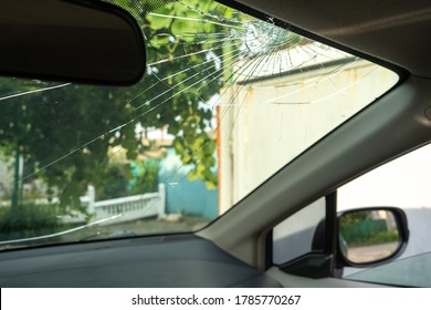 Broken Windshield With A Lot Of Cracks And Small Glass Pieces, Damaged Car