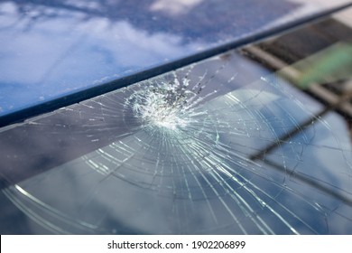 Broken Windshield With A Lot Of Cracks And Small Glass Pieces, Damaged Car