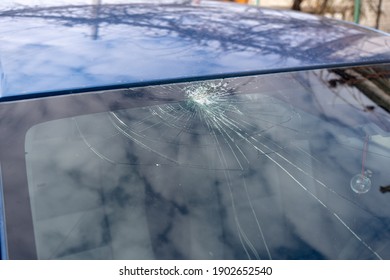 Broken Windshield With A Lot Of Cracks And Small Glass Pieces, Damaged Car