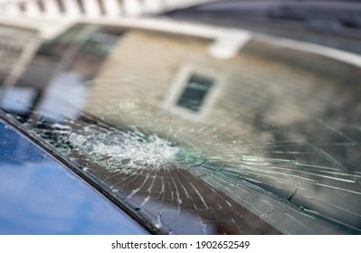 Broken Windshield With A Lot Of Cracks And Small Glass Pieces, Damaged Car