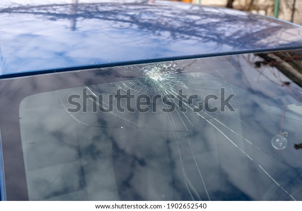 broken windshield with a lot of cracks and small\
glass pieces, damaged\
car