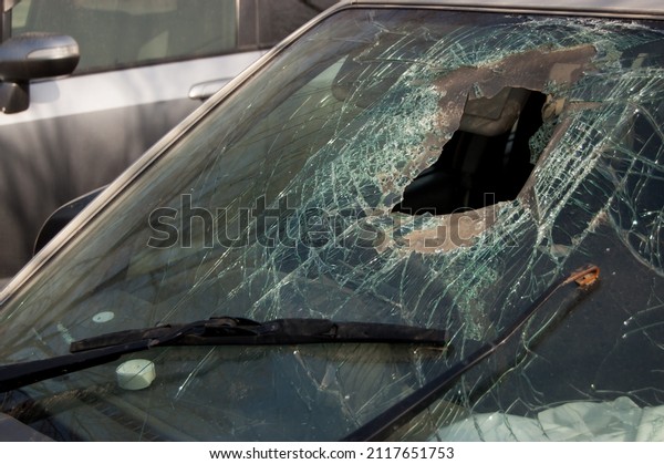Broken windshield with hole of the car involved\
in an accident.