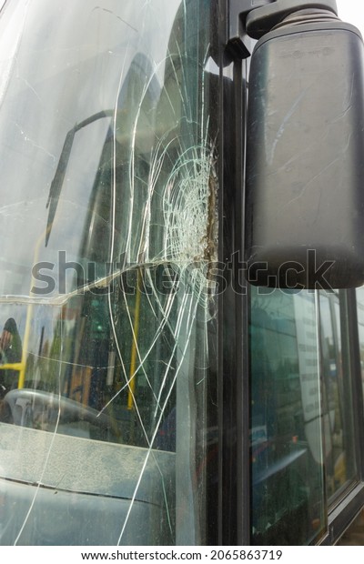 Broken windshield on a\
bus
