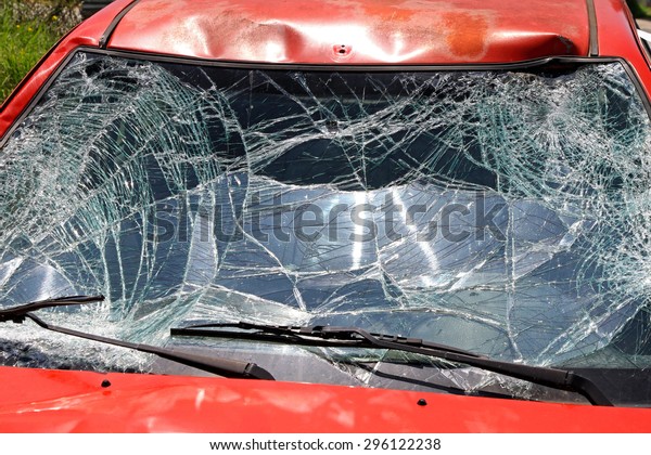 Broken\
Windshield at Red Car in Traffic\
Accident