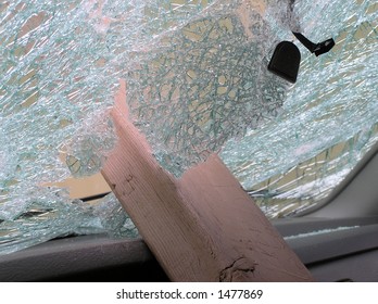 The Broken Windshield Of A Stolen & Vandalized Truck.  A Wooden 2X4 From A Park Bench Remains Lodged In The Center.