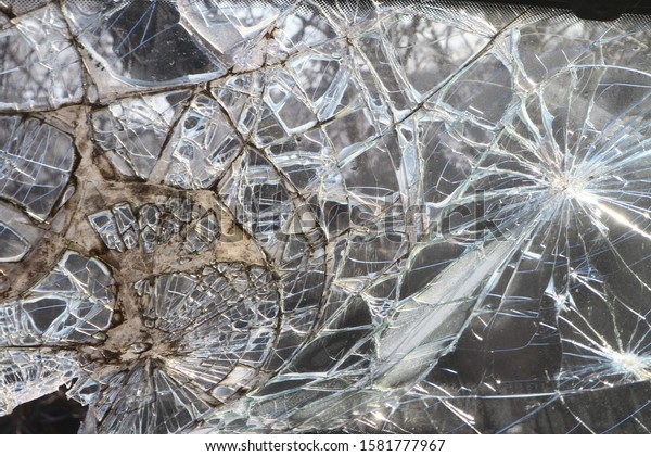 Broken windshield thick glass after car crash.
Bullet-resistant glass (ballistic or transparent armor).
Сonsequence of road incident. Traffic collision. Lethal head-on
collision involving two
vehicles