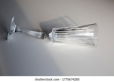 Broken Wine Glass Empty On White Background, Concept Of Collapse And Ruin