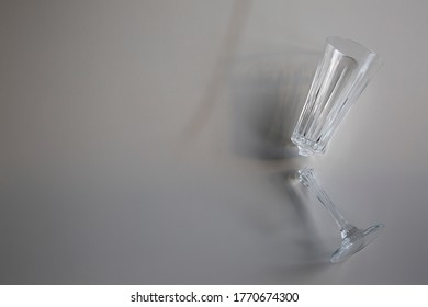 Broken Wine Glass Empty On White Background, Concept Of Collapse And Ruin