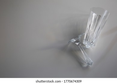 Broken Wine Glass Empty On White Background, Concept Of Collapse And Ruin