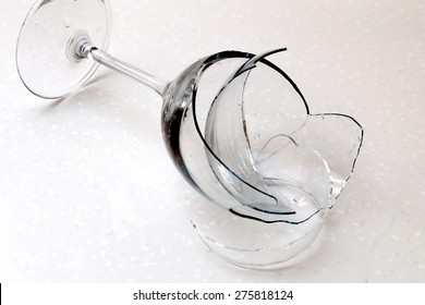 Broken Wine Glass On The White Table