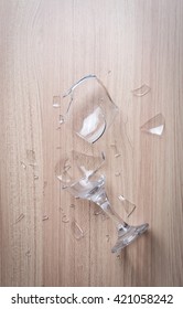 Broken Wine Glass On Wooden Floor