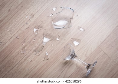 Broken Wine Glass On Wooden Floor