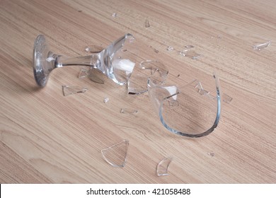 Broken Wine Glass On Wooden Floor