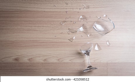 Broken Wine Glass On Wooden Floor