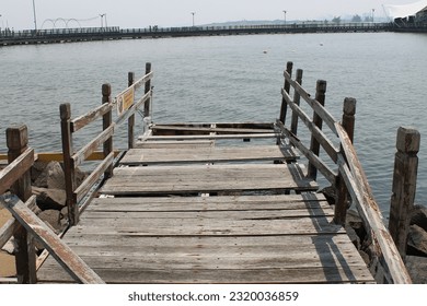 Broken wooden bridge at the edge of a seaside