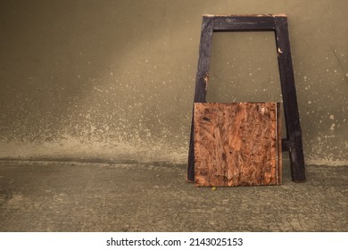 broken wooden chair lean back on wall
