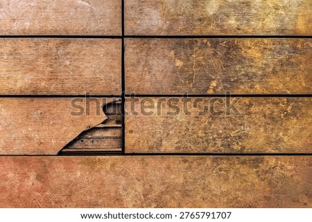 Broken WPC composite decking board on outdoor patio. Damaged hollow wood plastic composite floor. Broken hollow plank reveals internal structure and hidden clips. Hollow Core and Hidden Clip.