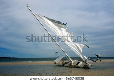 Broken yacht with a torn sail aground. Gulf Coast, Florida, St.  George Island