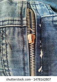 Broken Zip On Blue Jeans 