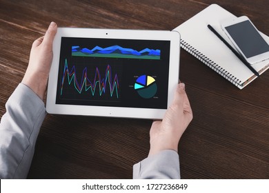 Broker using tablet at table, closeup. Forex trading