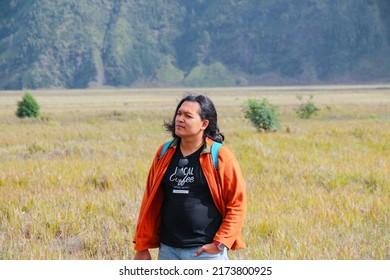 Bromo 26 June 2022 - Asian Guy With Long Hair Is Having Portrait Photo With A Beautiful Nature Background In Tengger District East Java During Holiday