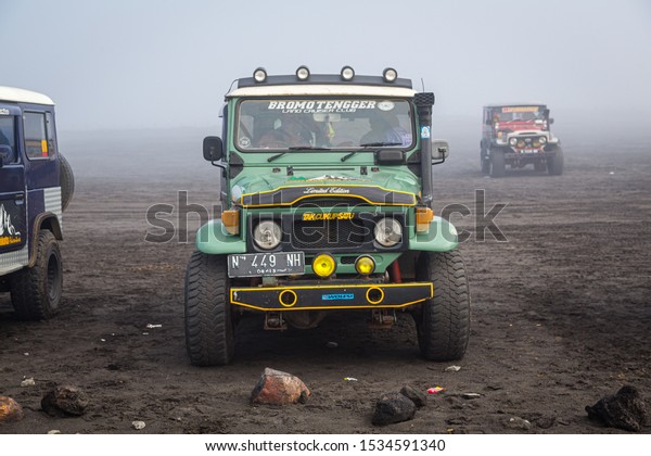Bromo Tengger Semeru National Park, East Java,\
Indonesia - February 8 2015: A green Toyota Land Cruiser at the\
parking in the caldera, waiting for the return of the tourist\
groups from the crater\
rim