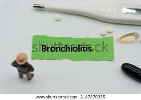 Bronchiolitis.The word is written on a slip of colored paper. health terms, health care words, medical terminology. wellness Buzzwords. disease acronyms.