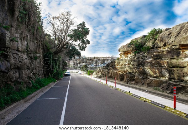 Bronte Beach car park\
between two rock cliffs with views of the houses on cliff tops\
Sydney Australia 