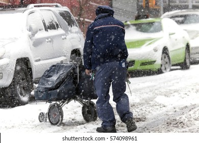 BRONX, NEW YORK - JANUARY 7:  Mail Man Pushes Mail Carriage During Snow Storm.  Taken January 7, 2017 In New York.