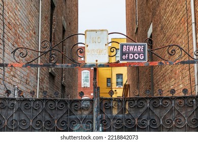 The Bronx, New York, USA. Beware Of Dog Sign On A Rusted Alley Gate.