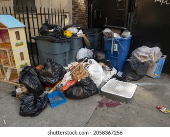 BRONX, NEW YORK, USA - September 20, 2021: Neglected Trash Left In Front Of Apartment Building Dwelling. 