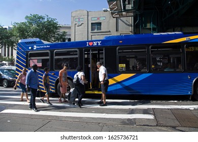 BRONX, NEW YORK/USA - July 3, 2019: Transit Worker Helps People Board Public Bus.