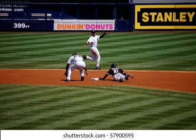BRONX, NY - AUGUST 30 - Alexei Ramirez of the White Sox steals second base against the Yankees as the throw comes up short to Robinson Cano in a game at Yankee Stadium August 30, 2009 in Bronx, NY