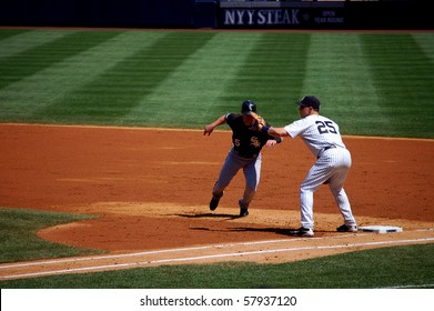 BRONX, NY - AUGUST 30: Jayson Nix of the Chicago White Sox avoids being picked off as Mark Teixeira of the New York Yankees covers first in a game at Yankee Stadium August 30, 3009 in Bronx, NY
