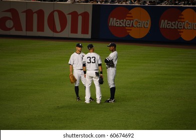 BRONX, NY - SEPTEMBER 7: During A Pitching Change, LF Brett Gardner, RF Nick Swisher And CF Curtis Granderson Talk In A Game Against The Orioles On September 7, 2010 In Bronx, NY.