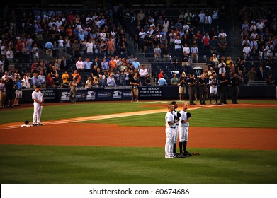 BRONX, NY - SEPTEMBER 7: Mark Teixeira, Nick Swisher, Curtis Granderson, Brett Gardner, Jorge Posada And The Umpires Stand At Attention During The National Anthem On September 7, 2010 In Bronx, NY.