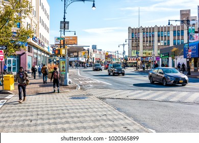 Bronx, USA - October 28, 2017: People crossing street in Fordham Heights center, New York City, NYC morning, cars, sunny day
