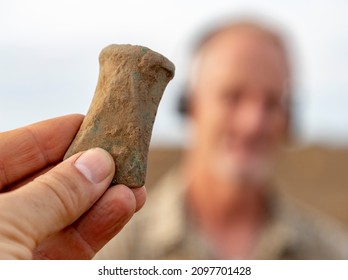 A Bronze Age Axe Found With Metal Detector, Finder In The Background