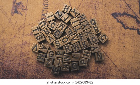 Bronze Alphabet Puzzle On Old World Map