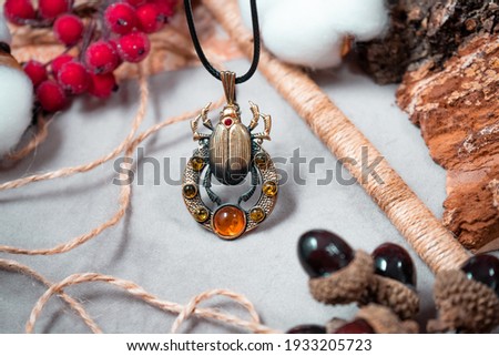 Bronze and amber pendant in the form of scarab.