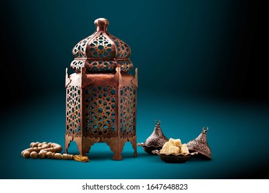 A Bronze Arabian Lamp With Islamic Rosary Beads On Desk