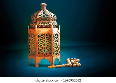 A Bronze Arabian Lamp With Islamic Rosary Beads On Desk