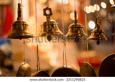 Bronze bells in Indian market with blurry background. Hindu temple bell