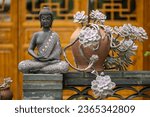 Bronze buddha statue against temple facade in Daci temple, downtown Chengdu, Sichuan province, China