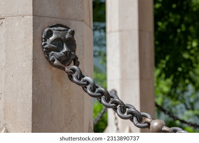 Bronze chain with holder in the shape of a lion's head.