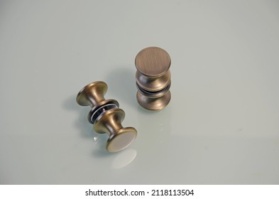 bronze glass door handle. Round brass handle. Metal handle for glass doors. Bronze-colored barrel-shaped knob