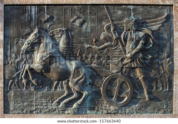 Bronze relief of Alexander the Great riding the chariot. Skopje, Macedonia
