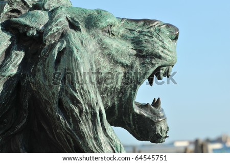 bronze sculpture of a lion roaring