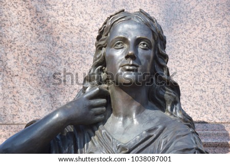 Bronze sculpture of a long-haired woman
